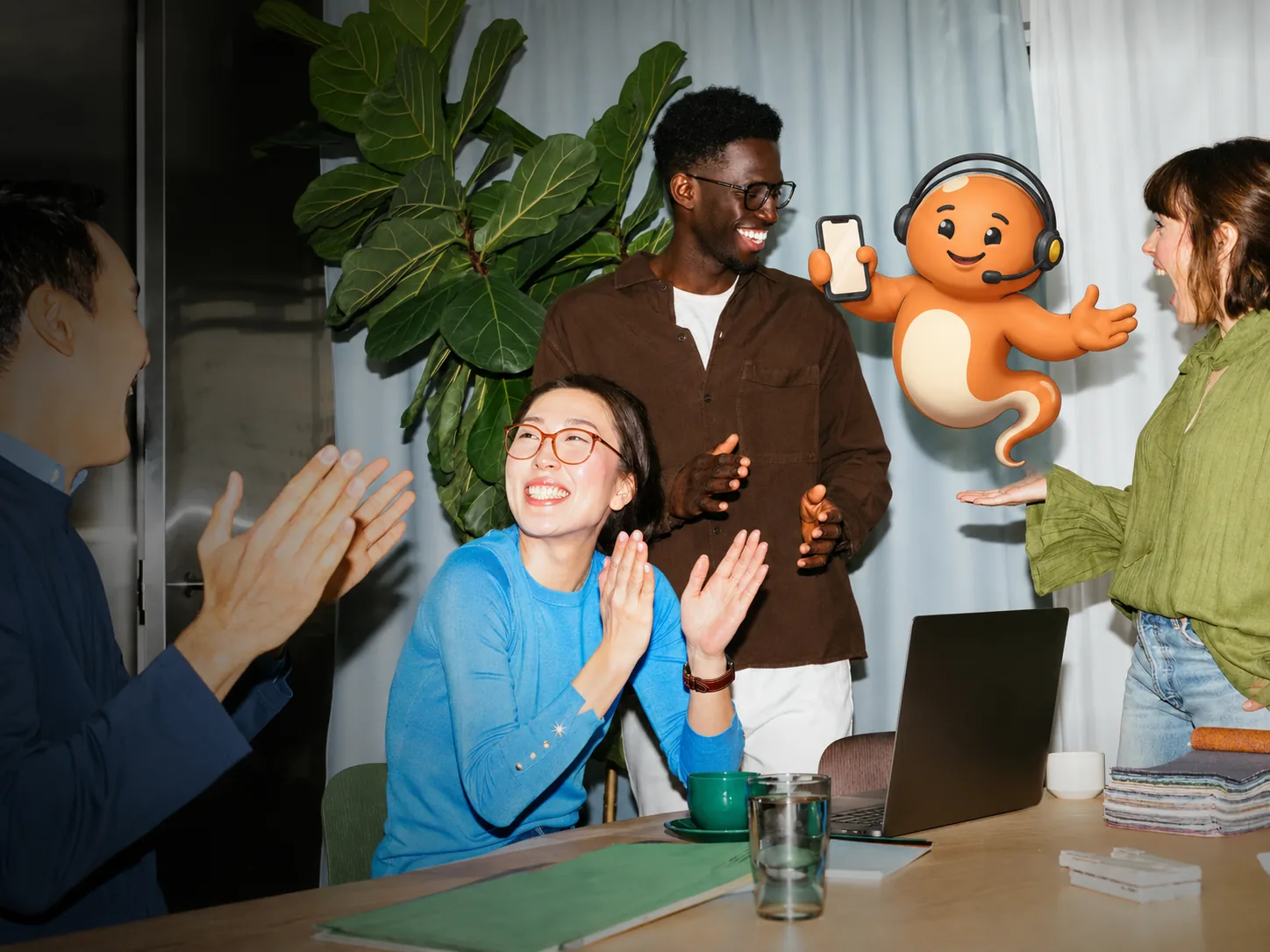 The Genie Central team around a laptop, the Genie alongside them